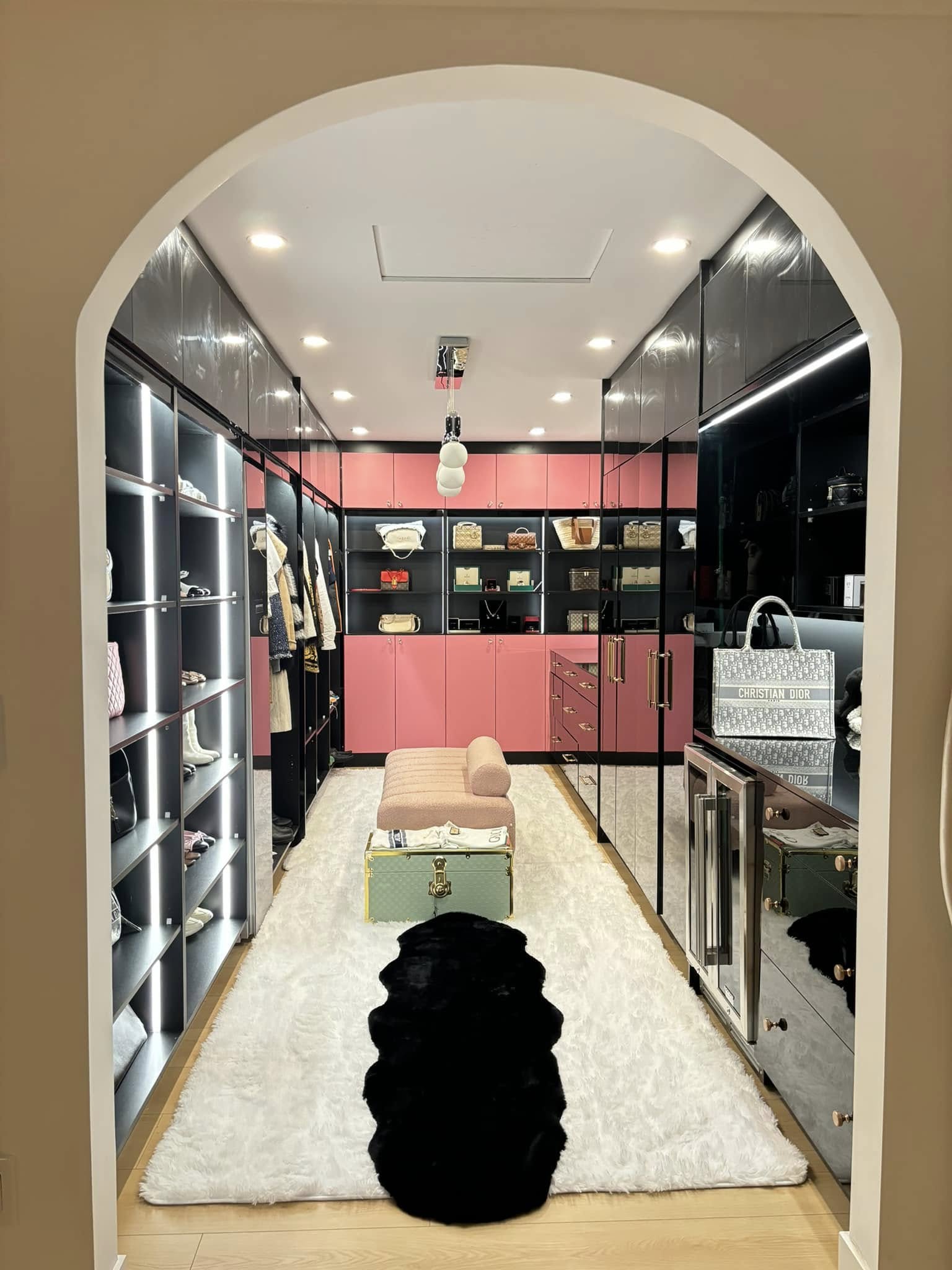 Luxury walk-in closet custom black pink cabinets illuminated shelving Vancouver